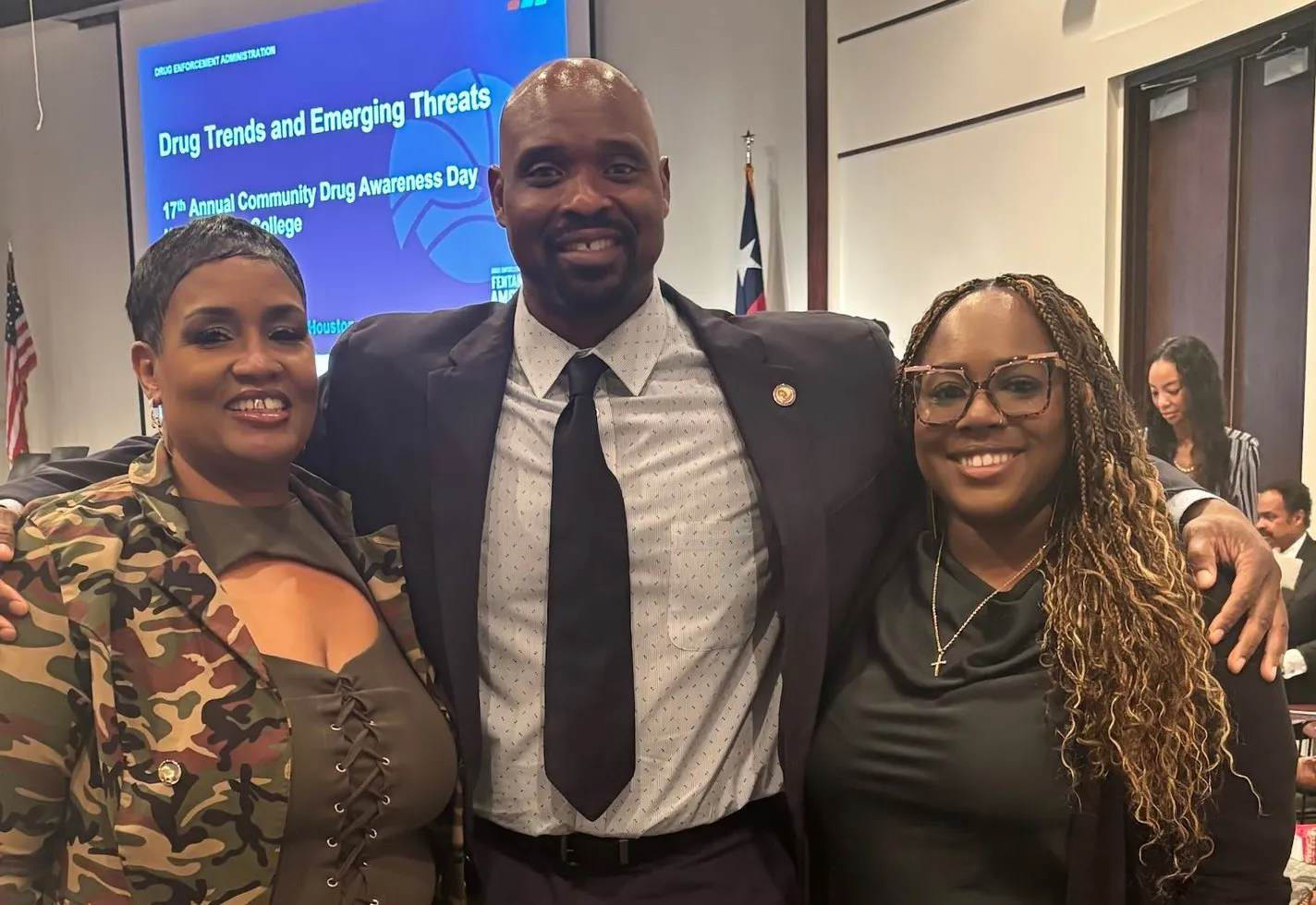 Three people smiling together at the 17th Annual Community Drug Awareness Day